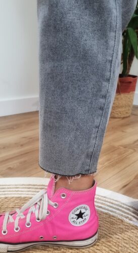 Détail de la finition effilochée du jean gris femme